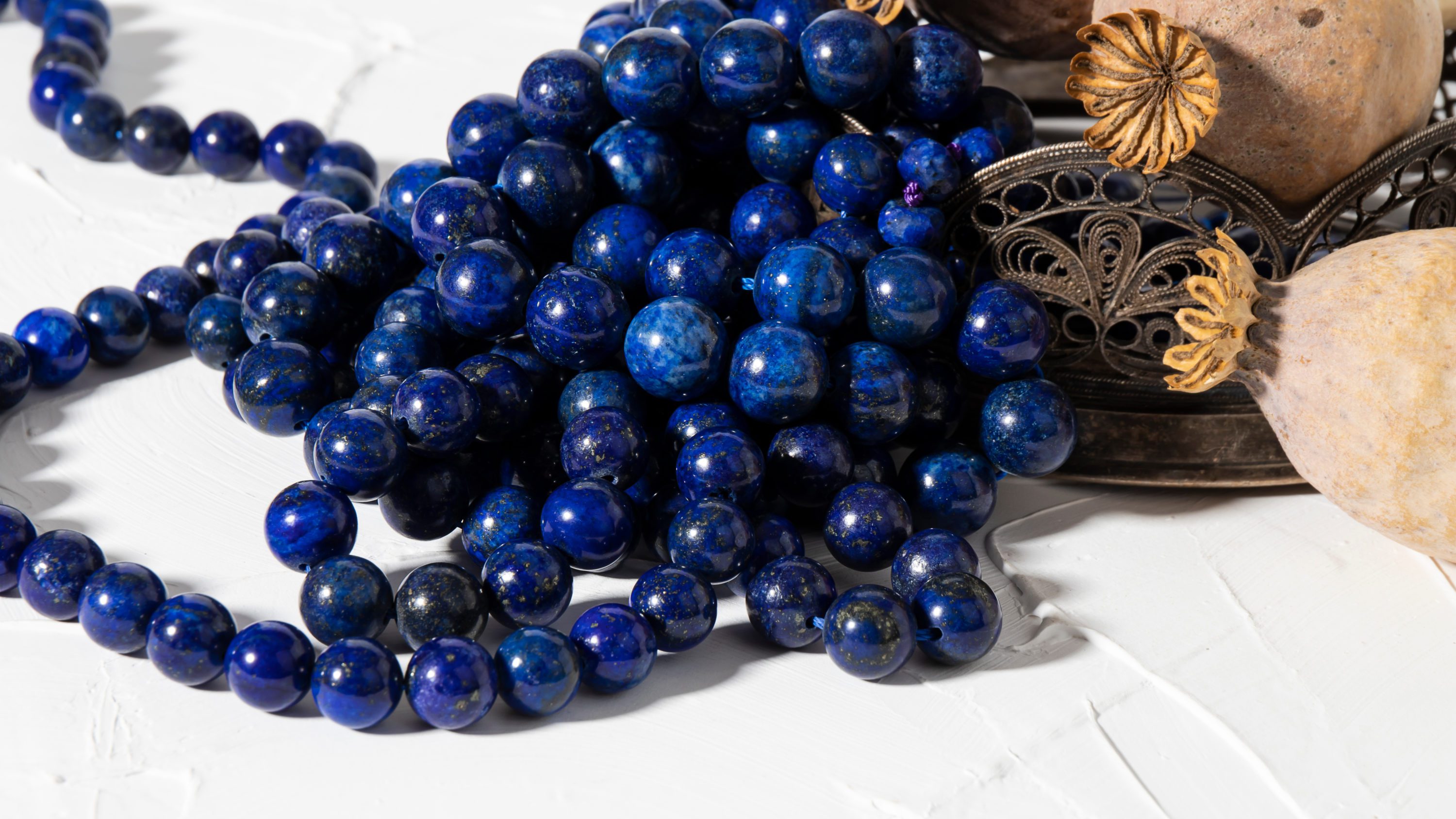 Beautiful bright  round blue lapis lazuli beads close up on a wh